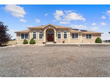 Stunning single story stucco home with a gravel driveway and manicured landscaping at 38087 E 147Th Pl, Keenesburg, CO 80643