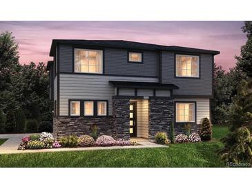 Two-story home with gray siding, stone accents, and landscaping at 23951 E 40Th Ave, Aurora, CO 80019