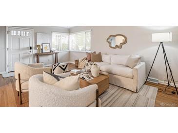 Bright living room featuring hardwood floors, stylish furnishings, and a large window for natural light at 3620 Fairfax St, Denver, CO 80207