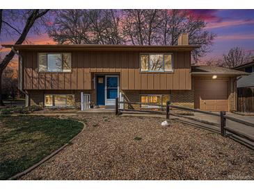 Charming two-story home featuring a split-level design and a well-maintained front yard with attractive stone landscaping at 1529 Ashcroft Dr, Longmont, CO 80501