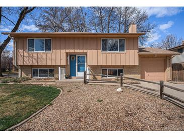 Charming two-story home with a blue door, well-maintained landscaping, and a cozy, inviting appeal at 1529 Ashcroft Dr, Longmont, CO 80501