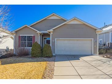 Charming single-Gathering home featuring neutral siding, an attached two-car garage, and a well-maintained front yard at 22134 Wintergreen Way, Parker, CO 80138