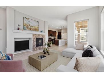 Bright living room featuring a fireplace, modern decor, and an open floor plan at 5895 S Taft Ct # H, Littleton, CO 80127