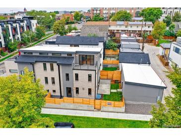 Aerial view of a modern three-story home with a private backyard and detached garage at 3205 Quivas St, Denver, CO 80211