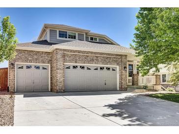 Charming two-story home featuring a three-car garage and well-maintained front yard at 20394 E Colgate Pl, Aurora, CO 80013