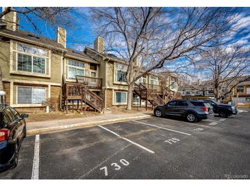 Exterior view of townhome with parking and landscaping at 1885 S Quebec Way # 16, Denver, CO 80231