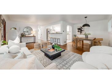 Bright living room featuring modern furniture, hardwood floors, and an open floor plan to the kitchen at 2090 Irving St, Denver, CO 80211