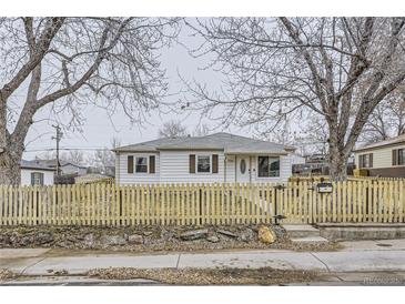 Ranch style home with wood fence and landscaping at 1840 Rowena St, Thornton, CO 80229