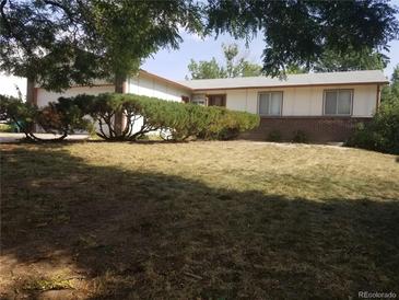 Ranch style home with attached garage and mature landscaping at 2832 S Mobile St, Aurora, CO 80013