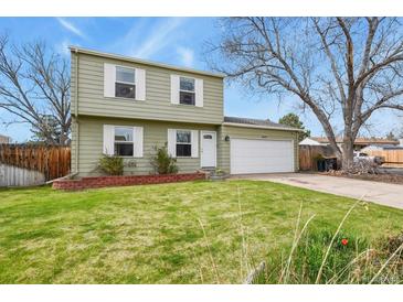 Charming two-story home featuring a well-maintained front lawn, a two car garage and classic curb appeal at 10645 Moore Ct, Broomfield, CO 80020