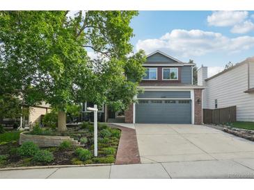 Charming two-story home with a well-manicured lawn and a spacious two-car garage at 6307 Monterey Pl, Highlands Ranch, CO 80130