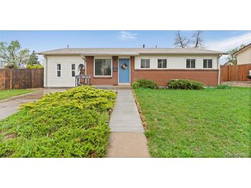 Charming single-story home with a brick facade and well-maintained lawn, with a walkway leading to the front door at 3100 W 94Th Ave, Westminster, CO 80031