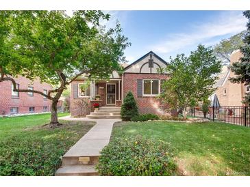 Charming brick home with a well-manicured lawn and inviting front porch at 1259 S Elizabeth St, Denver, CO 80210