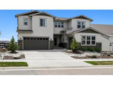 Charming two-story home with a three car garage and professionally landscaped front yard at 6851 Copper Sky Cir, Castle Pines, CO 80108