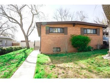 Charming brick home with a well-maintained lawn and a walkway leading to the front entrance at 5431 S Hickory St, Littleton, CO 80120