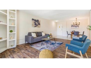 Inviting living room featuring modern decor, hardwood floors, and a stylish area rug at 2231 S Vaughn Way # 317 B, Aurora, CO 80014