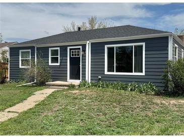 Charming single story home with new gray horizontal siding, white trim, and a well-manicured front yard at 1100 N Hanover St, Aurora, CO 80010