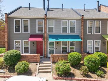Charming townhomes boast colorful awnings, brick accents, and well-manicured landscaping at 1150 Inca St # 39, Denver, CO 80204