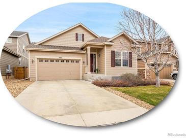 Charming two-story home with a two-car garage and well-manicured lawn, situated in a desirable neighborhood at 668 E Dry Creek Cir, Littleton, CO 80122