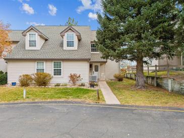 Charming home exterior featuring dormer windows, manicured lawn, and mature landscaping at 2182 S Victor St # D, Aurora, CO 80014