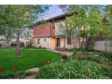 Striking modern home with lush landscaping and a welcoming front yard with beautiful lawn and garden areas at 3665 Estes St, Wheat Ridge, CO 80033