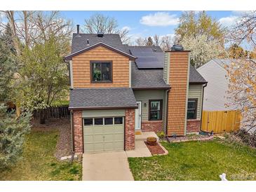 Charming two-story home featuring brick accents, solar panels, and a well-maintained front yard at 5773 W 76Th Dr, Arvada, CO 80003