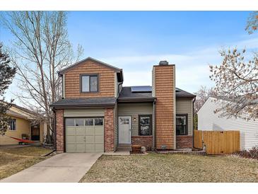 Charming two-story home features a blend of brick and cedar siding, plus a convenient attached garage at 5773 W 76Th Dr, Arvada, CO 80003