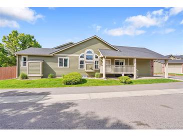 Charming home featuring an inviting front porch, manicured lawn, and appealing architectural details at 4825 S Ammons St # 133, Littleton, CO 80123