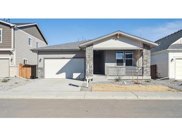 Charming single-Gathering home with a two-car garage, stone accents, and well-maintained landscaping at 230 Lark Sparrow Way, Bennett, CO 80102