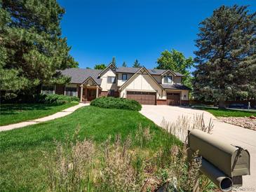 Charming two-story home with well-maintained landscaping and a spacious driveway at 15395 E Penwood Pl, Aurora, CO 80015