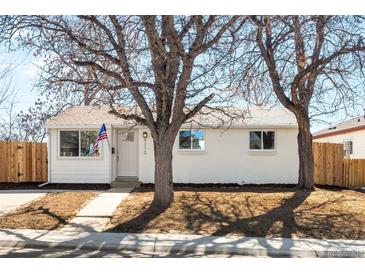 Charming single-story home with manicured front yard and white exterior, showcasing curb appeal at 4210 S Dale Ct, Englewood, CO 80110