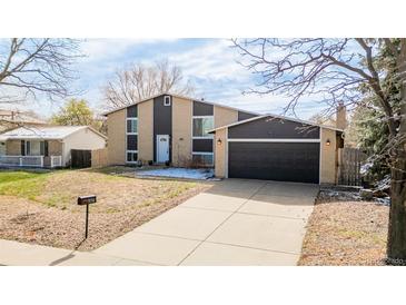 Charming two-story home with a well-manicured lawn and attached two car garage at 3134 S Fairplay St, Aurora, CO 80014