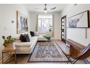 Bright living room featuring a comfortable white sectional sofa and stylish rug at 1922 E 18Th Ave, Denver, CO 80206