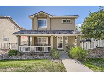 Charming two-story home with a covered front porch, landscaped yard, and a welcoming entrance at 11832 Zenobia Loop, Westminster, CO 80031