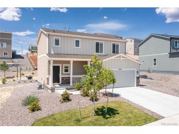 Charming two-story home with a well-maintained yard and inviting front porch, perfect for enjoying the neighborhood view at 42741 Ivydel Cir, Elizabeth, CO 80107