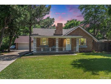 Charming brick home with a lush front lawn and a welcoming porch, perfect for relaxing outdoors at 11940 W Independence Ave, Lakewood, CO 80401