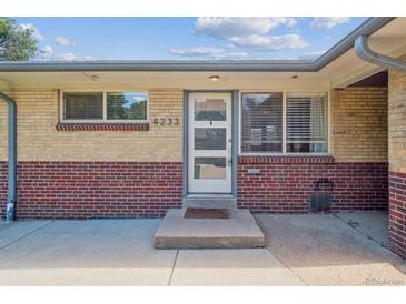 Brick facade with a front door and large windows offering plenty of natural light at 4233 Shoshone St, Denver, CO 80211