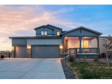 Beautiful two-story home featuring a two-car garage and inviting covered porch at 1845 Meagan Way, Erie, CO 80516