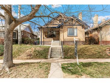 Charming brick home with inviting front yard and classic architectural details at 2663 King St, Denver, CO 80211
