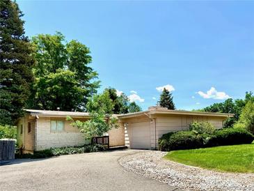 Charming single-story home with a well-manicured lawn and inviting curb appeal at 6040 W Elmhurst Dr, Littleton, CO 80128