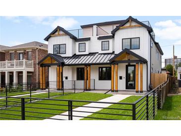 Modern two-story home with white siding, black trim, manicured lawn, and a black metal fence at 1571 Vrain St, Denver, CO 80204