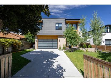 Contemporary two-story home with a concrete driveway and a glass paneled garage door, complemented by landscaping at 3485 S Clermont St, Denver, CO 80222