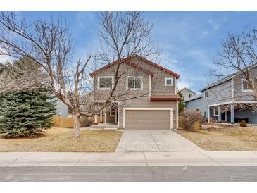 Charming two-story home features a two-car garage and well-maintained front yard at 11213 Vilas St, Parker, CO 80134