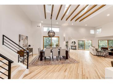Bright dining room features wood floors, vaulted ceiling with wooden beams, modern lighting and views to the outdoors at 2857 Linden Dr, Boulder, CO 80304