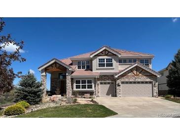 Beautiful two-story home featuring a well-manicured lawn and an attached two car garage at 23965 E Kettle Pl, Aurora, CO 80016