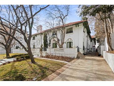 Grand two-story white home with a red tile roof, green trim, and landscaped front yard at 704 N Pearl St # 0-323, Denver, CO 80203