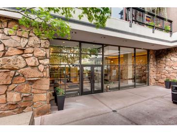 Modern building entrance featuring glass doors, stone accents, and clear signage for easy access at 1020 15Th St # 20F, Denver, CO 80202