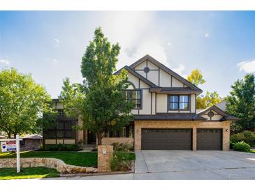 Charming home with a three-car garage, lush landscaping, and a well-maintained front yard at 57 Mc Intyre Cir, Golden, CO 80401
