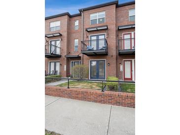 Brick townhomes offer private balconies with wrought iron railings and beautifully landscaped front yards at 4108 W 118Th Pl, Westminster, CO 80031