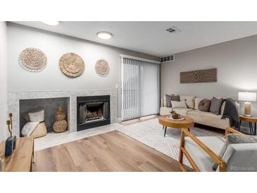 Inviting living room features a fireplace and decorative wall art, offering a cozy and stylish ambiance at 2575 S Syracuse Way # B101, Denver, CO 80231